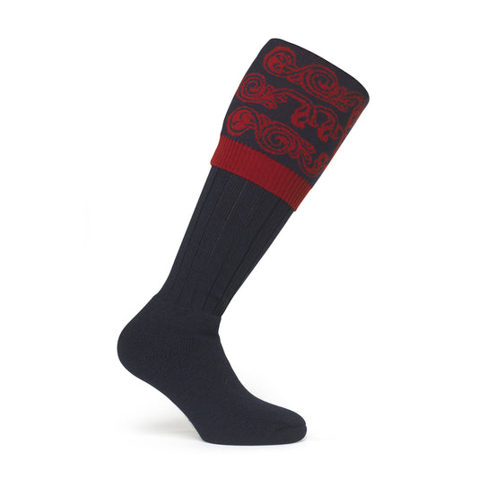 Image showcasing a country boot welly sock with intricate scroll details at the top, made from luxurious merino wool. Crafted in England and made to order by a sustainable company, epitomizing timeless style and eco-conscious craftsmanship