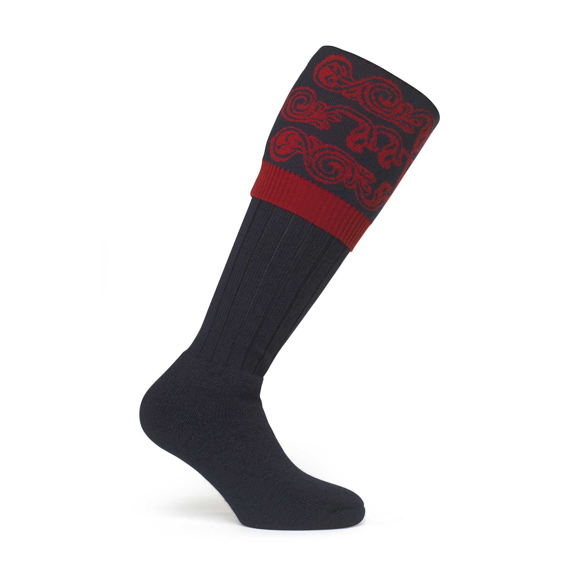 Image showcasing a country boot welly sock with intricate scroll details at the top, made from luxurious merino wool. Crafted in England and made to order by a sustainable company, epitomizing timeless style and eco-conscious craftsmanship