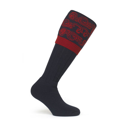 Image showcasing a country boot welly sock with intricate scroll details at the top, made from luxurious merino wool. Crafted in England and made to order by a sustainable company, epitomizing timeless style and eco-conscious craftsmanship